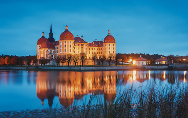 Moritzburg Castle near Dresden, in the night illumination reflected in the water. Wonderful autumn sunrise in Saxony, Dresden, Germany, Europe. Popular Places for photographers. Creative image