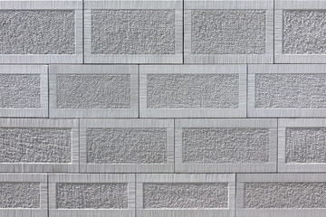 Detail einer Wand aus grauem viereckigen Sandstein mit Muster