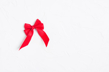 Red bow on white textured background