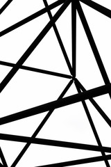 Detail of steel construction of Tetrahedron in Bottrop, Germany captured on a black and white photography taken from below against the sky. The site design is reminiscent of the Sierpinski tetrix