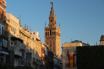 Fototapeta na wymiar Famous tower of Giralda, Islamic architecture built by the Almohads and crowned by a Renaissance bell tower with the statue of Giraldillo at its highest point, Seville Cathedral.