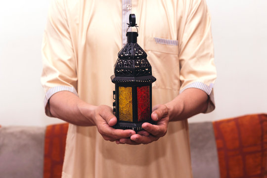 Arab Muslim man holding lantern ready for eid  and Ramadan Kareem concept.