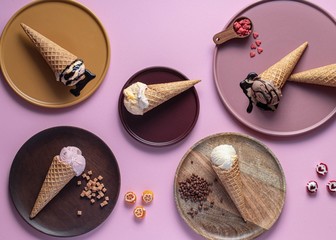 Several icecreams on plate with pink background