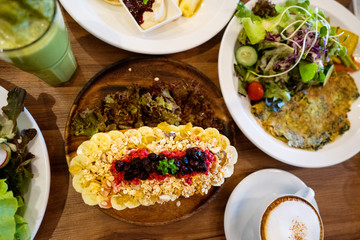 plates with dishes. stand on steel, salads, desserts and fruits