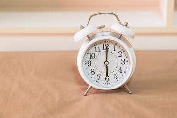 Naklejka premium Alarm clock on the bed, Wakes up in the morning , Vintage