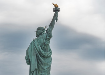 Fototapeta premium USA, New York - May 2019: Statue of Liberty, Liberty Island against an overcast sky