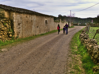 Mother and children hiking through the meadow