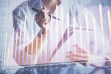 Financial chart drawn over hands taking notes background. Concept of research. Multi exposure