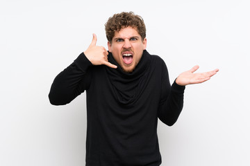 Blonde man over isolated white wall making phone gesture and doubting