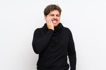 Blonde man over isolated white wall with toothache