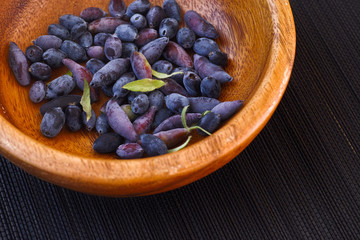 Blue fly honeysuckle in a wooden bowl