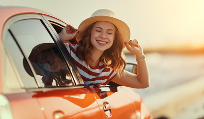 happy woman girl goes to summer travel trip in   car.