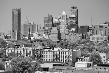 Black and white picture of Manhattan seen from Brooklyn neighborhood on a hazy summer day, USA.