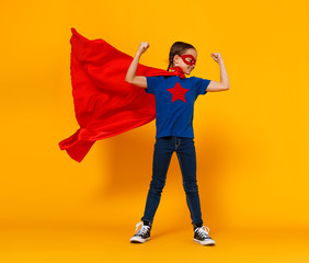 concept of child superhero costume on yellow background