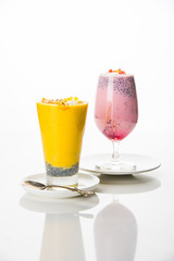 Falooda / Faluda is a popular Indian dessert - Strawberry and Mango flavoured which has Ice cream, noodles, sweet basil seeds and nuts, selective focus