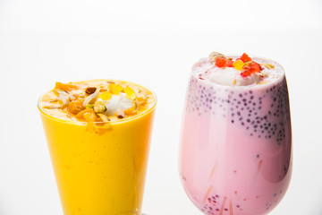 Fototapeta premium Falooda / Faluda is a popular Indian dessert - Strawberry and Mango flavoured which has Ice cream, noodles, sweet basil seeds and nuts, selective focus