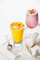 Falooda / Faluda is a popular Indian dessert - Strawberry and Mango flavoured which has Ice cream, noodles, sweet basil seeds and nuts, selective focus