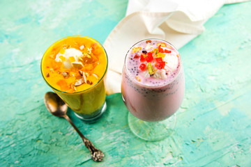 Falooda / Faluda is a popular Indian dessert - Strawberry and Mango flavoured which has Ice cream, noodles, sweet basil seeds and nuts, selective focus