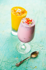 Falooda / Faluda is a popular Indian dessert - Strawberry and Mango flavoured which has Ice cream, noodles, sweet basil seeds and nuts, selective focus