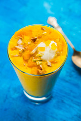 Falooda / Faluda is a popular Indian dessert - Strawberry and Mango flavoured which has Ice cream, noodles, sweet basil seeds and nuts, selective focus