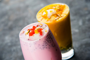 Falooda / Faluda is a popular Indian dessert - Strawberry and Mango flavoured which has Ice cream, noodles, sweet basil seeds and nuts, selective focus