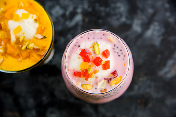 Falooda / Faluda is a popular Indian dessert - Strawberry and Mango flavoured which has Ice cream, noodles, sweet basil seeds and nuts, selective focus