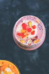 Falooda / Faluda is a popular Indian dessert - Strawberry and Mango flavoured which has Ice cream, noodles, sweet basil seeds and nuts, selective focus