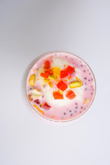 Falooda / Faluda is a popular Indian dessert - Strawberry and Mango flavoured which has Ice cream, noodles, sweet basil seeds and nuts, selective focus