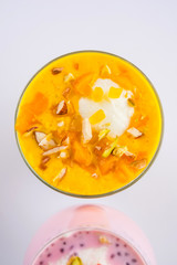 Falooda / Faluda is a popular Indian dessert - Strawberry and Mango flavoured which has Ice cream, noodles, sweet basil seeds and nuts, selective focus