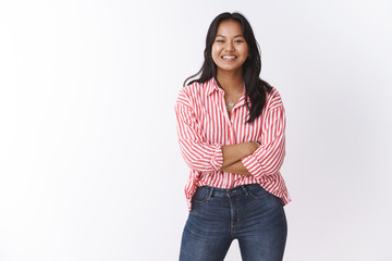 Cute and happy young female coworker smiling broadly starting own business encouraged for success...