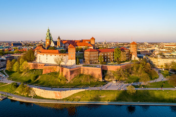 Historic royal Wawel castle and Cathedral in Cracow, Poland with park and Vistula river. Aerial view at sunset