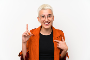 Teenager girl with short hair over white wall with surprise facial expression