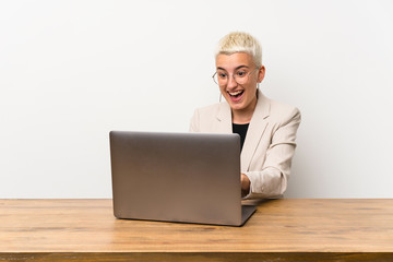 Happy Teenager girl with short hair with a laptop