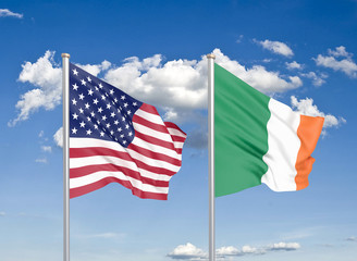 United States of America vs Ireland. Thick colored silky flags of America and Ireland. 3D illustration on sky background. - Illustration