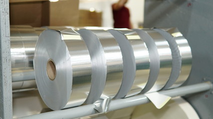 Shiny foil rolls for cigarettes packing in a tobacco factory