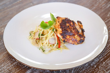 Lemongrass chicken breast with green mango salad, casual dining restaurant food