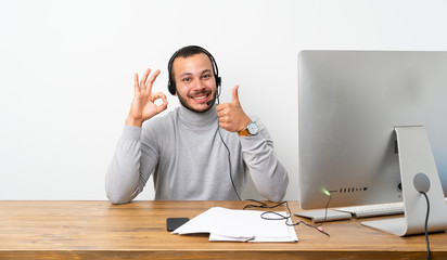Telemarketer Colombian man showing ok sign and thumb up gesture