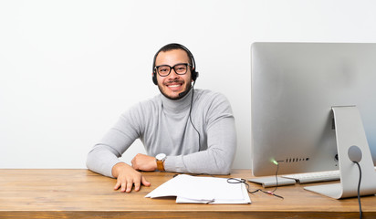 Telemarketer Colombian man with glasses and happy