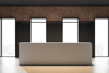 Reception in black and brick office with windows