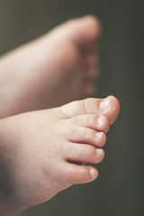 Beautiful feet of a little newborn. Close up image of a chubby foot with syndactyly. Background out of focus. Details of a baby relaxing peaceful.