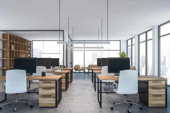 White open space office with wooden tables