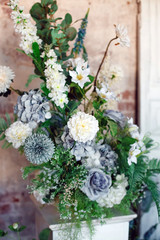 Flower decoration. Wedding decor. Flower interior composition in the studio. Spring photo zone. White doors. 