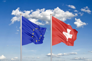 European Union vs Switzerland. Thick colored silky flags of European Union and Switzerland. 3D illustration on sky background. - Illustration