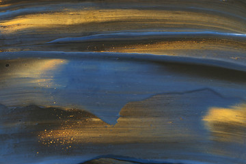 Abstract marbleized effect background. Blue and black creative colors. Beautiful paint with the addition of gold
