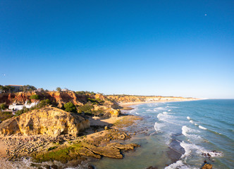 Fototapeta na wymiar Algarve, Portugal aerial view on beach and coast of Atlantic Ocean. Hotels zone on Cliffs in Praia de Falesia Albufeira 