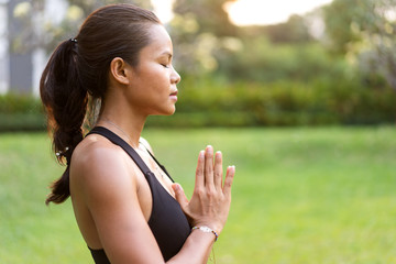 girl doing yoga at sunset in Thailand in the park