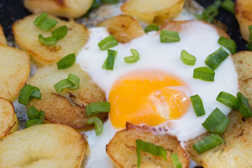 fried eggs and potatoes with chive