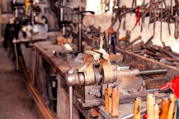 Tools hanging on the wall and old wooden bench in a workshop. Carpentry, craftsmanship, handwork o father's Day concept.