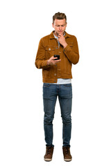 Fototapeta premium Blonde handsome man thinking and sending a message