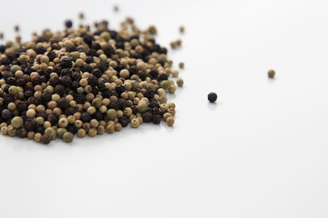 Three colors pepper scattered on white table